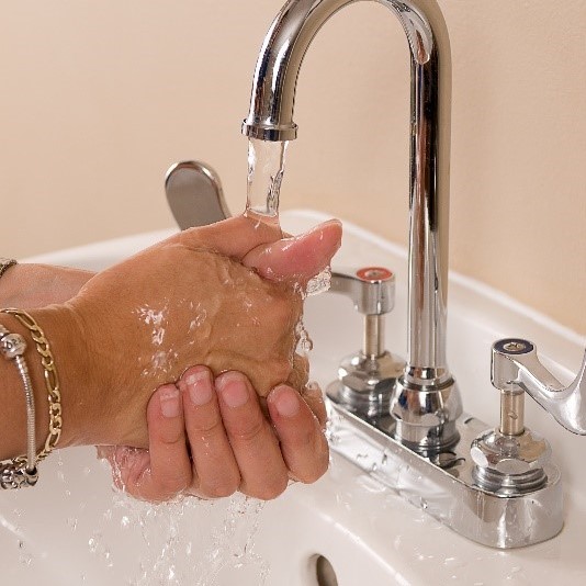 Hands washing at sink