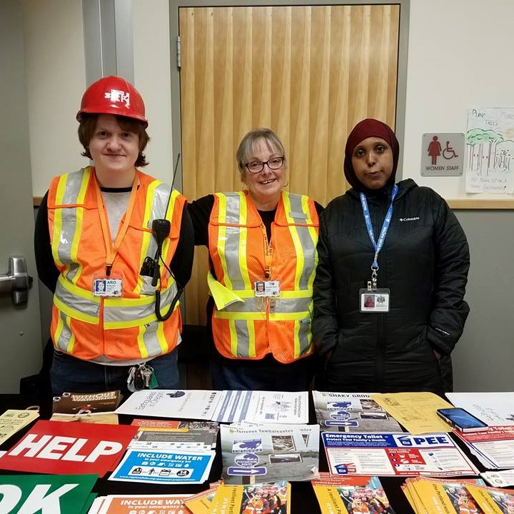 Portland Neighborhood Emergency Team members staff a booth and answer questions about emergency preparedness at an outreach event in Argay Parkrose.